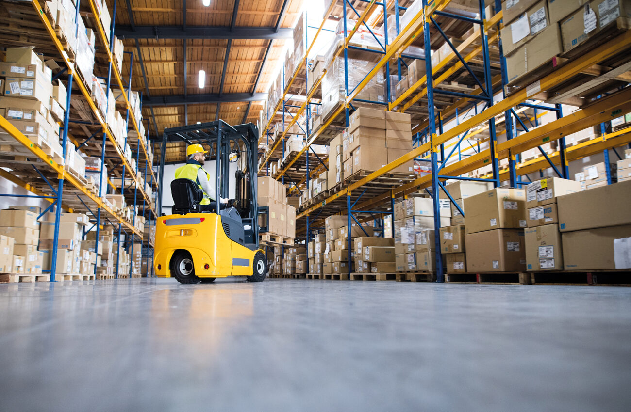 Warehouse man worker with forklift.