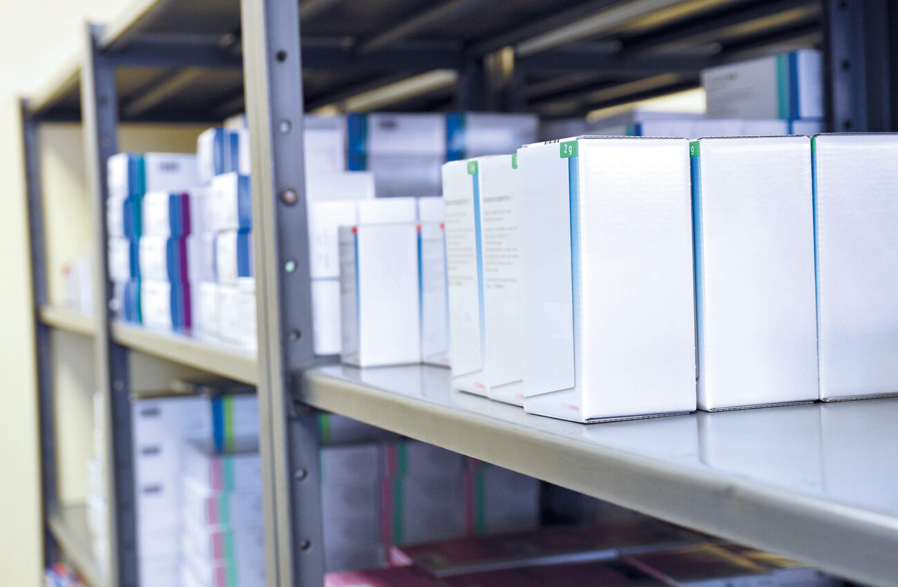 Drug boxes in a shelf in a pharmacy. Store of medicines and vita